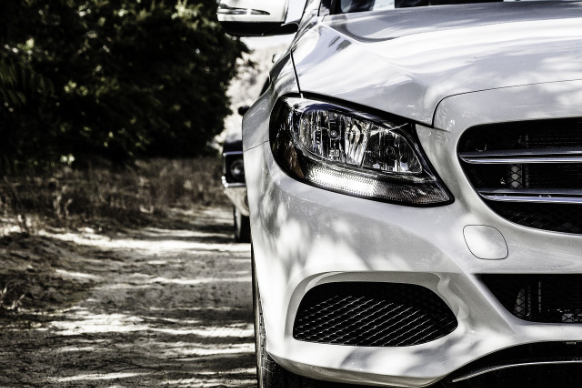 A white Mercedes-Benz parked for car inspection.